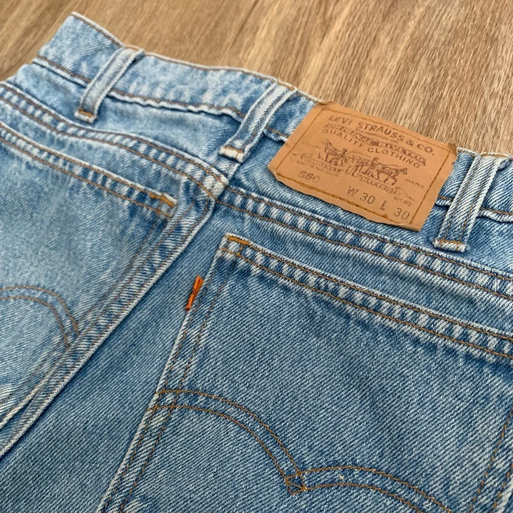Vintage 80s Levi's 550 orange tab tapered leg denim jeans in light wash - 30x30‎